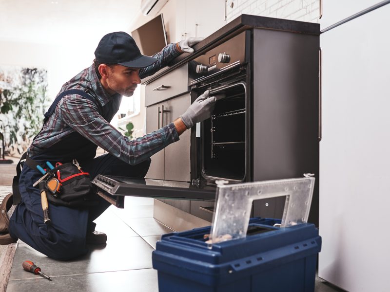 Don't,Delay,With,Repair.,Close up,Of,Repairman,Examining,Oven,With
