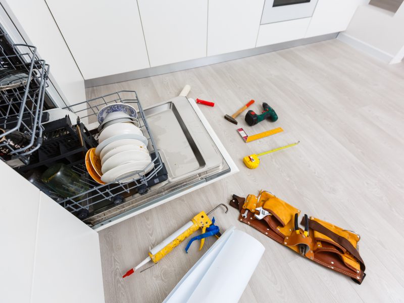 Home,Dishwasher,Appliance,Being,Repaired,In,A,Kitchen